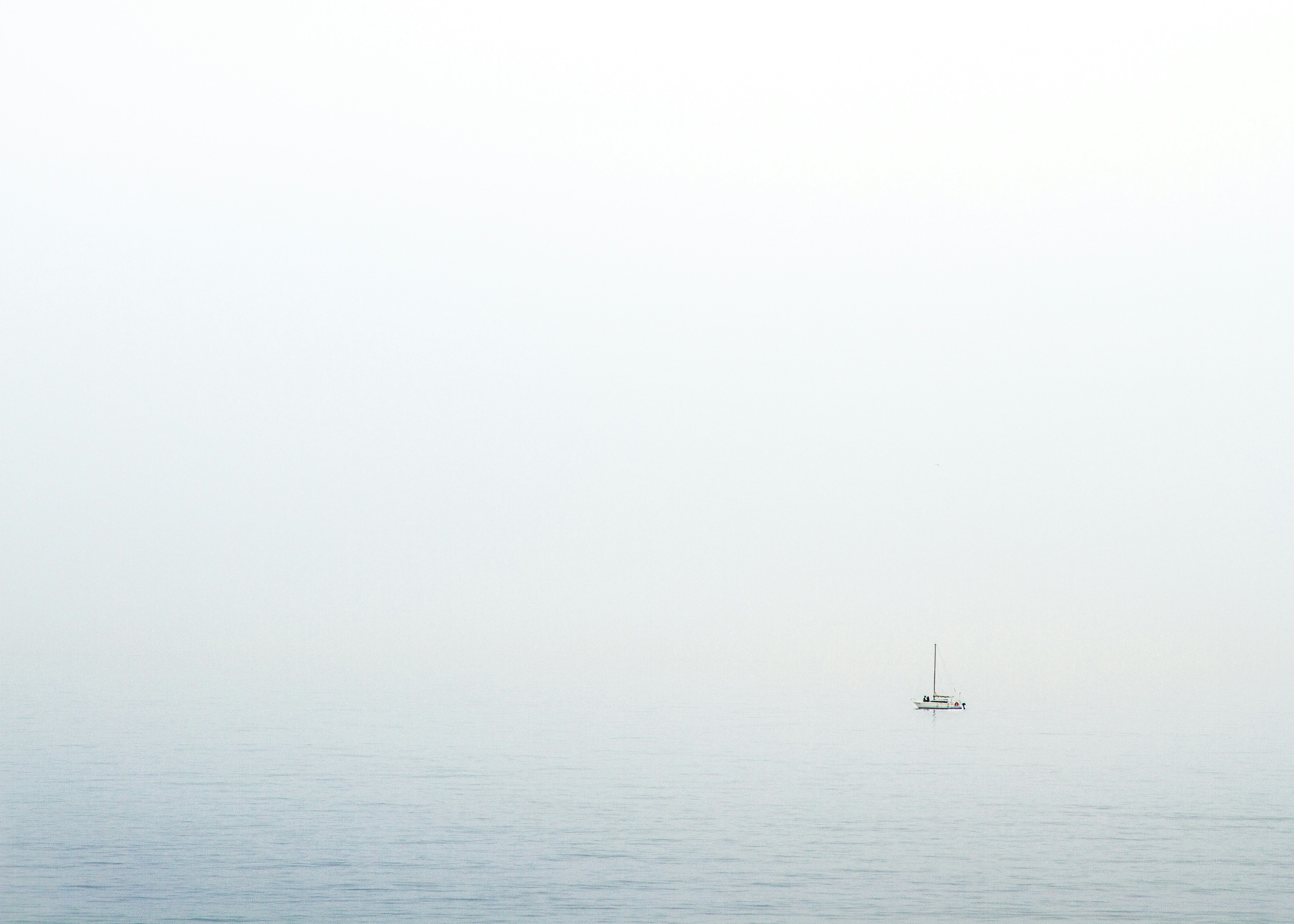 body of water under white sky during daytime